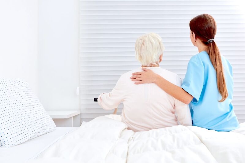 Nursing home bed with white linen